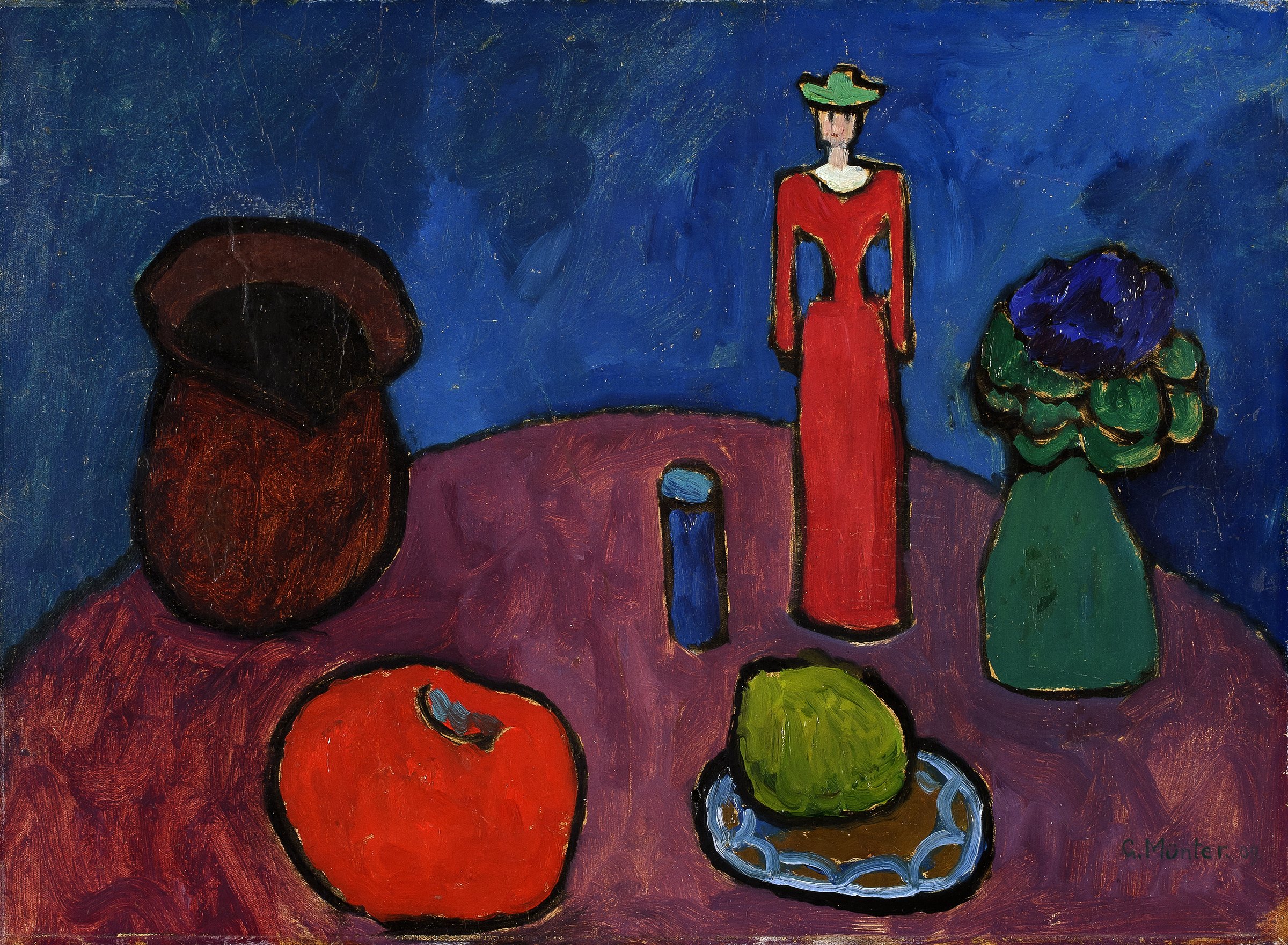 Gabriele Münter, Wooden Doll: a still life of a wooden doll, fruit and a jug on a red tablecloth
