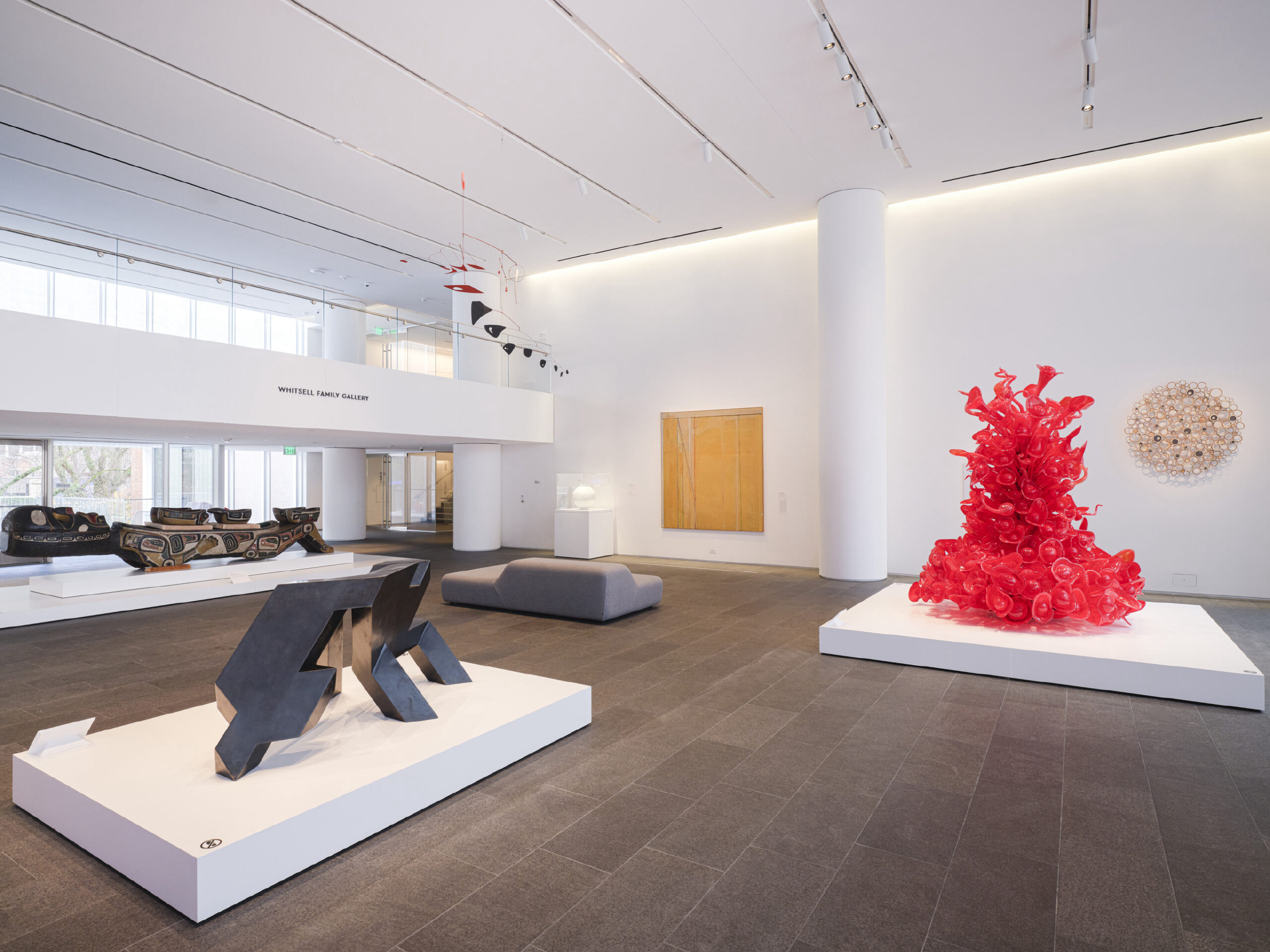 Gallery installation photo with various artworks in view.
