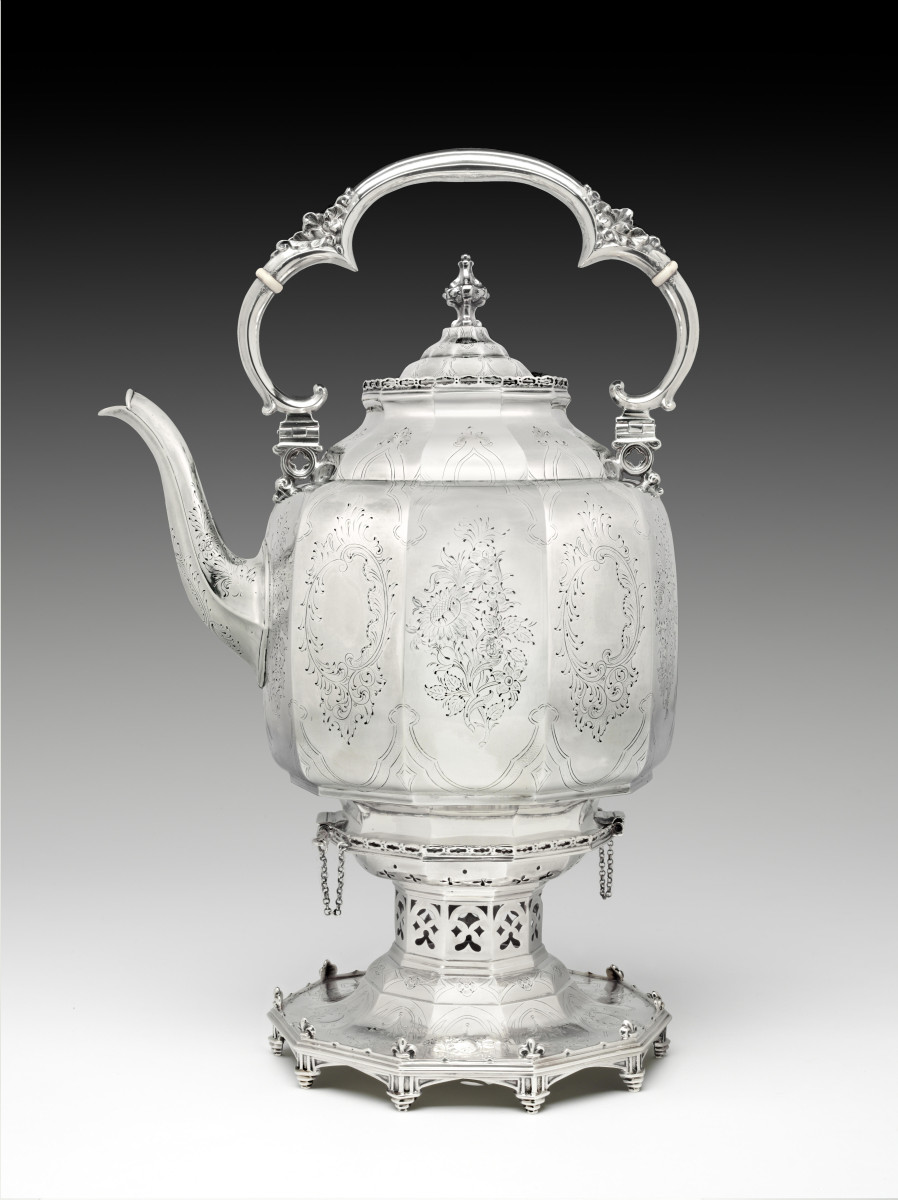 Hot water kettle on stand by Ball, Tompkins & Black: an engraved silver kettle with a scrolled handle on a pierced stand