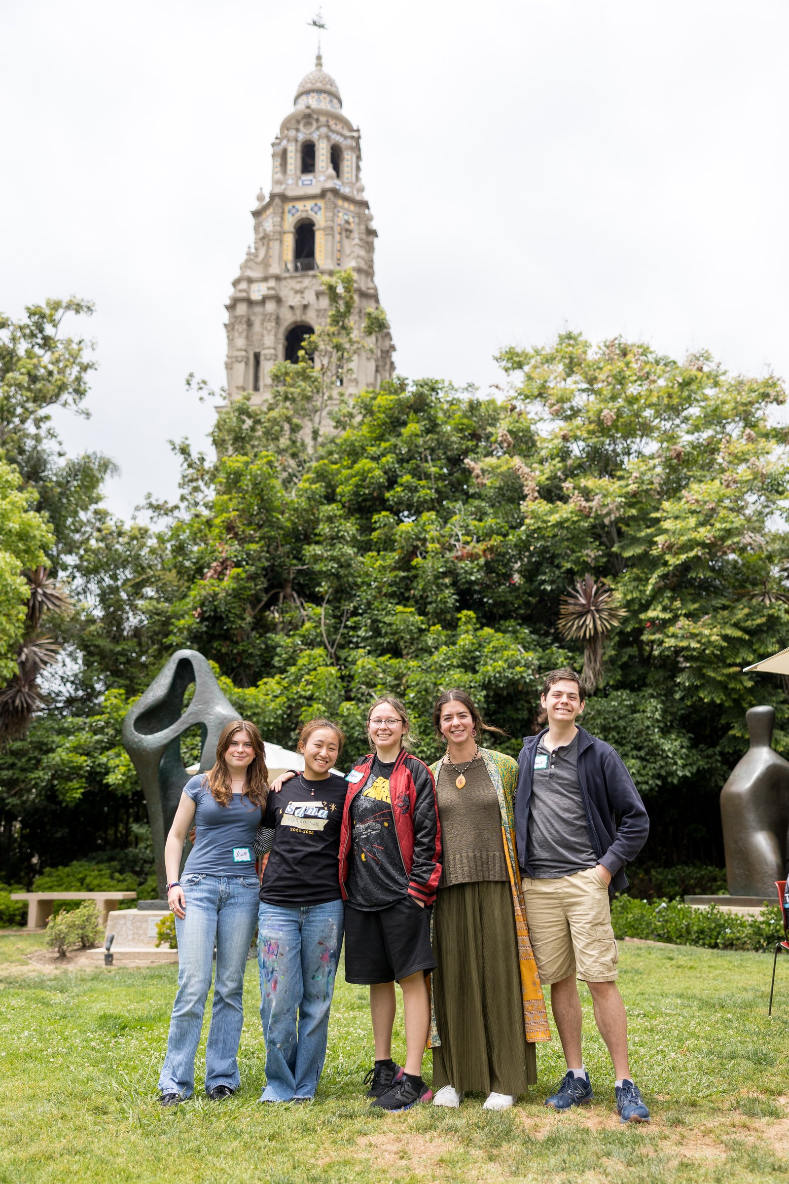 A group of visitors in the garden with the California Tower behind them