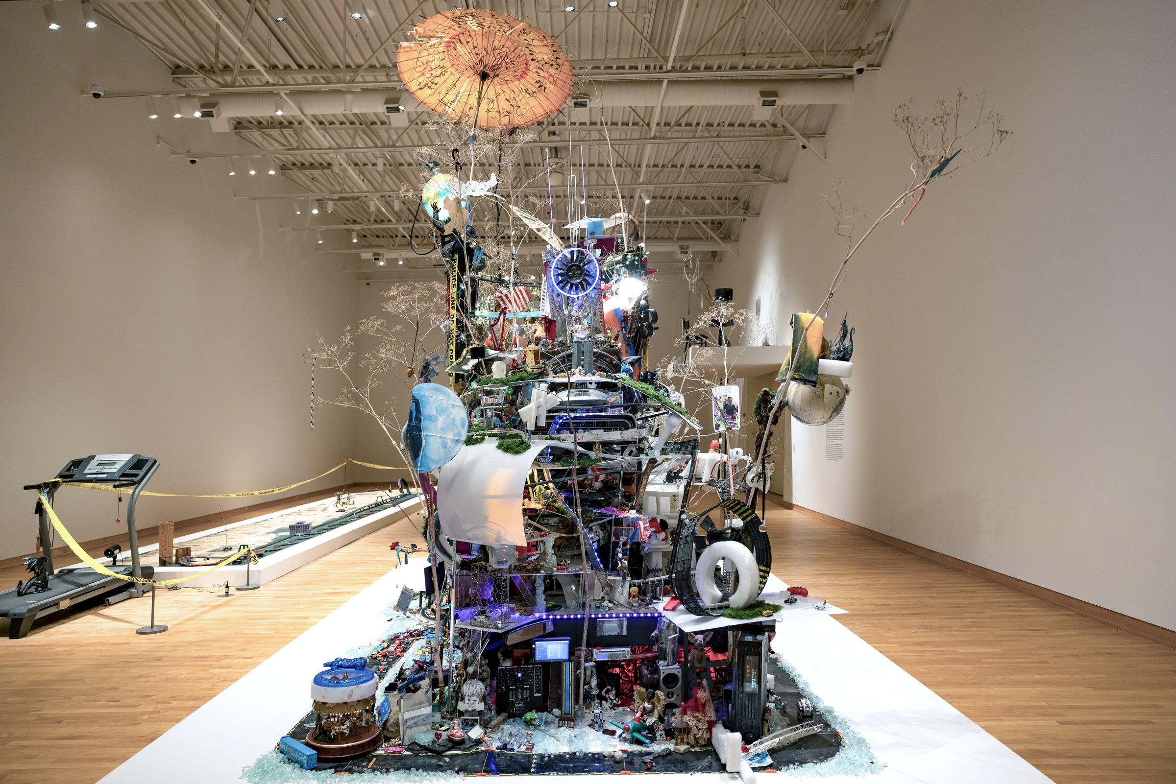 Robert Blackstone’s Crystal City, a large mixed-media miniature city, installed in a long white gallery