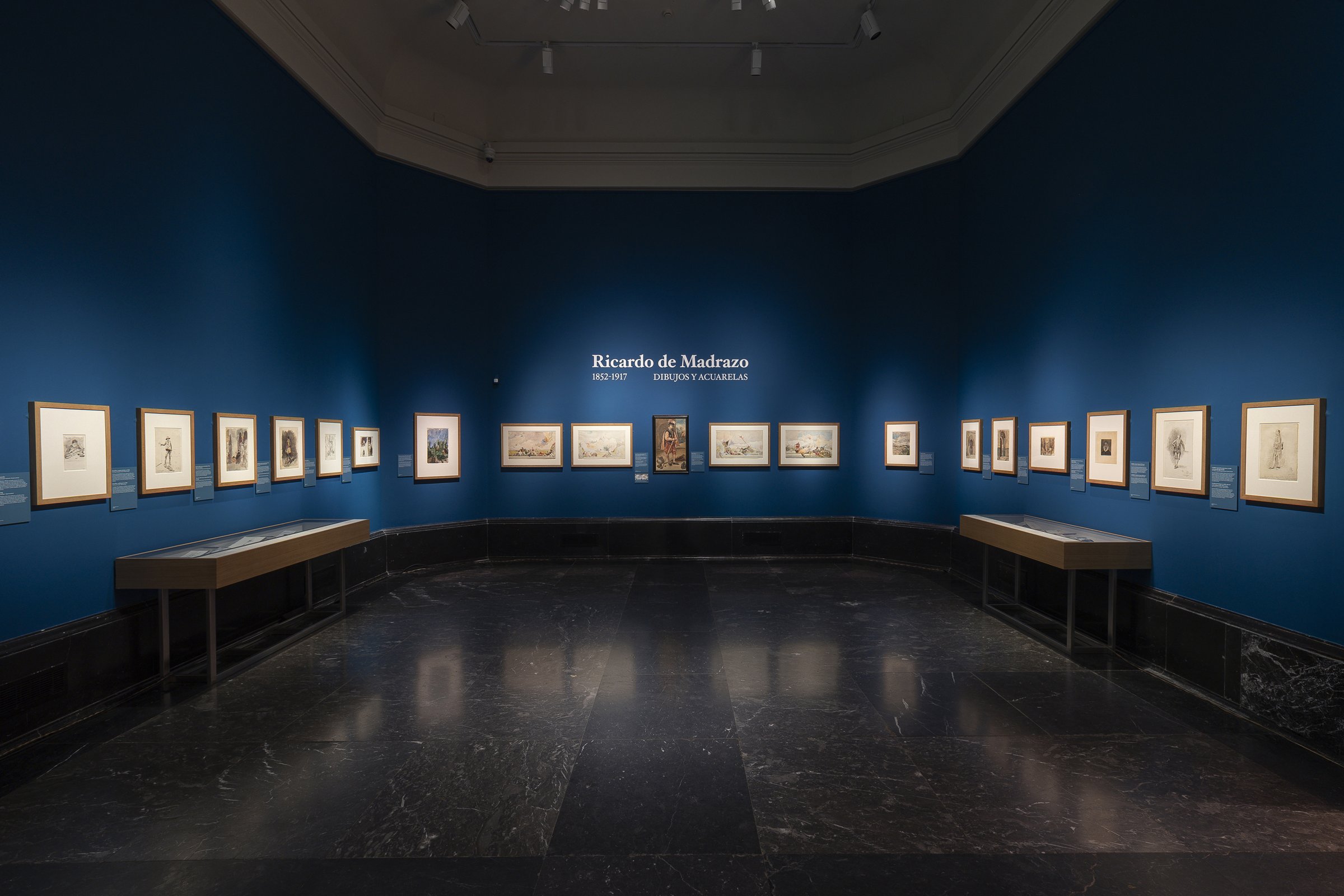 Gallery view of Ricardo de Madrazo (1852–1917): dibujos y acuarelas at the Museo del Prado, with framed drawings along blue walls