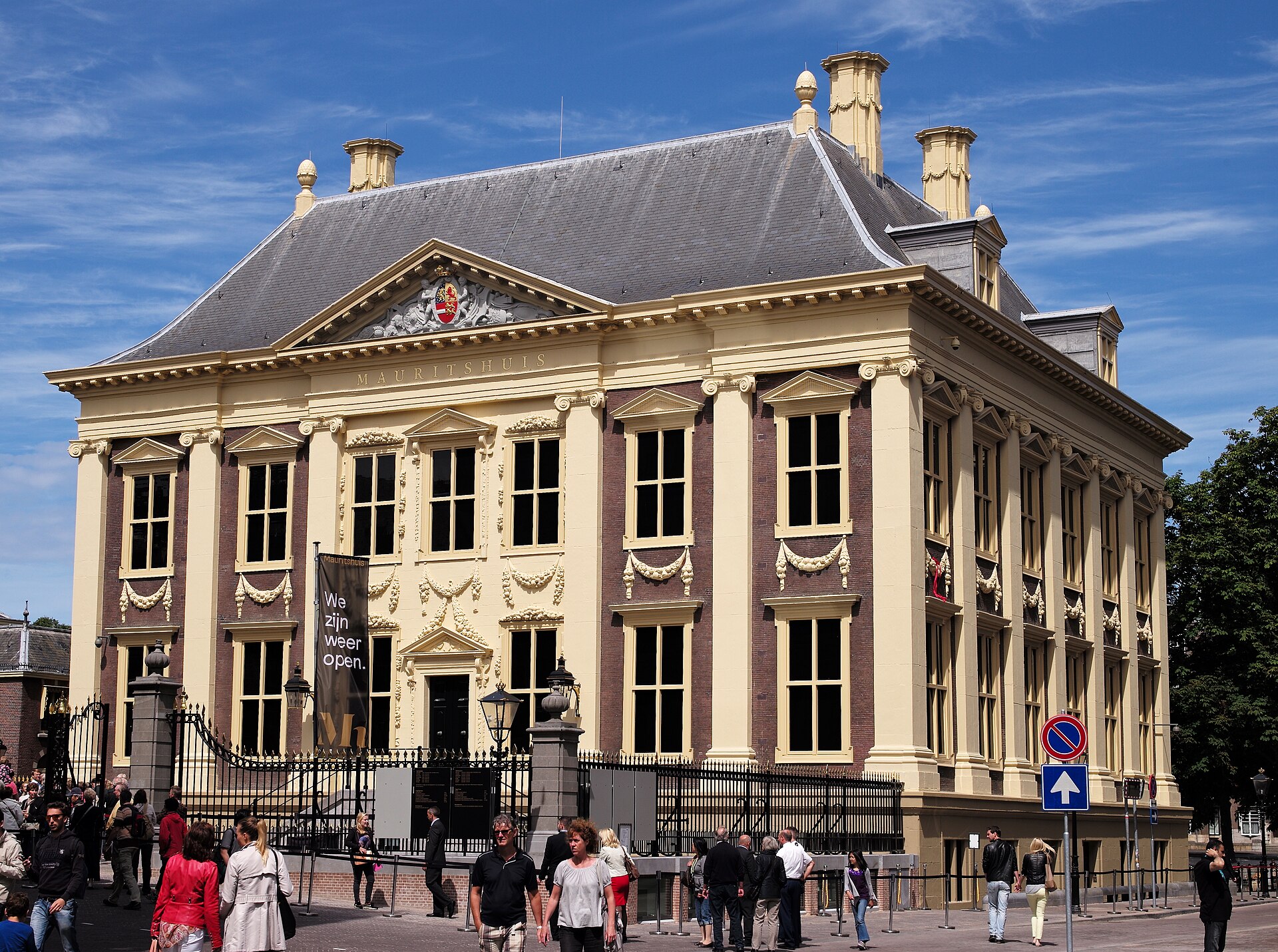 The Mauritshuis in The Hague: a compact seventeenth-century classical mansion of brick and sandstone with pilasters and a pedimented front, beside the Hofvijver pond.