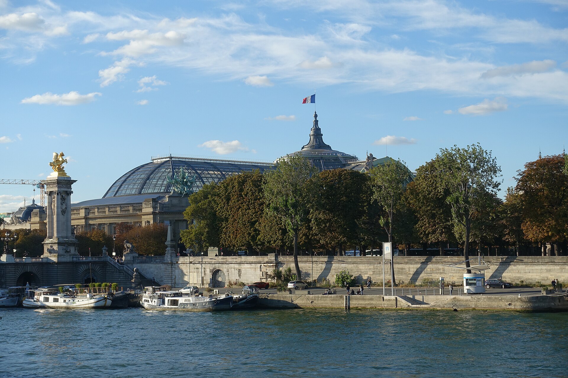 The glass dome of the Grand Palais in Paris seen across the Seine beside the Pont Alexandre III.