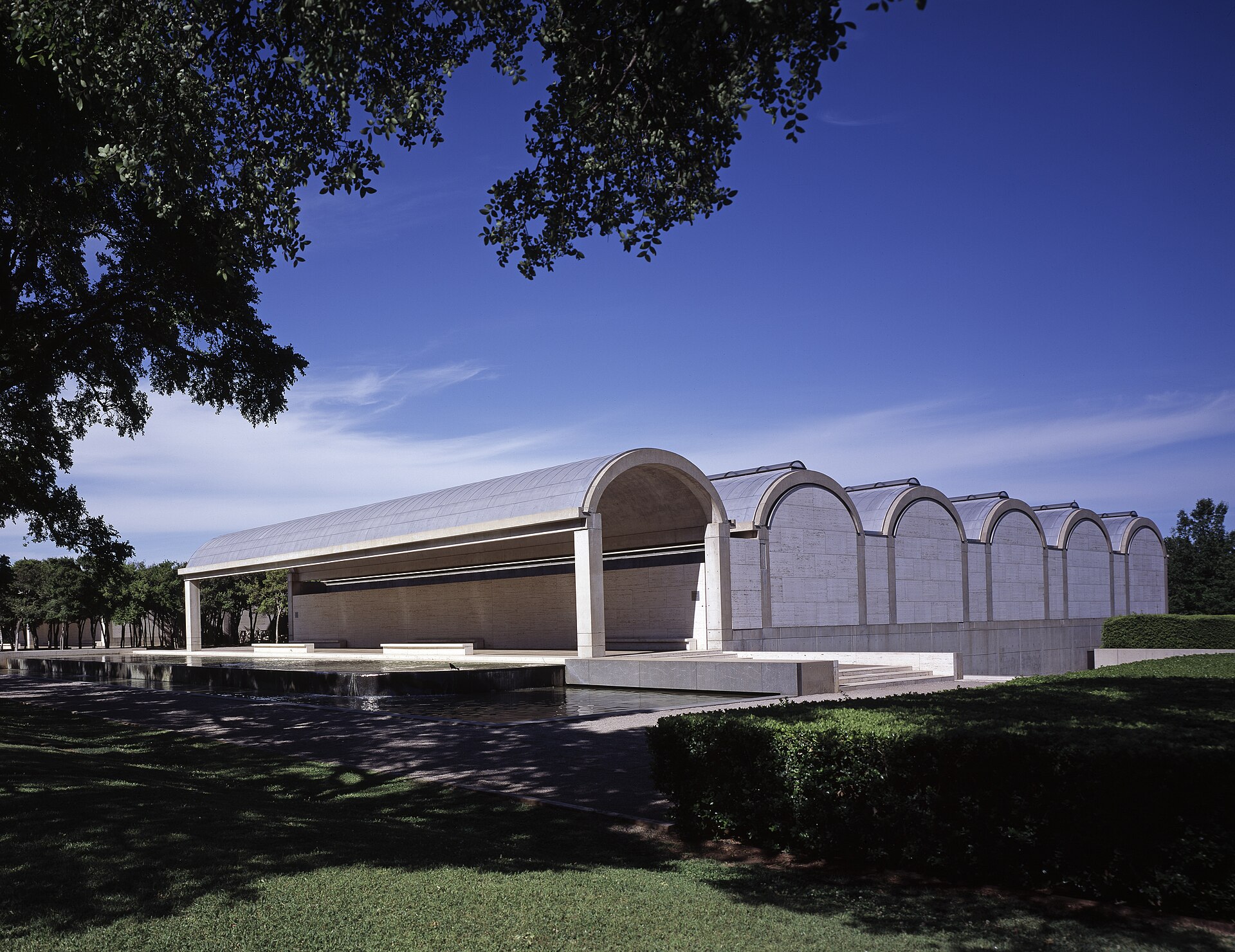 The vaulted concrete roof of Louis Kahn's Kimbell Art Museum in Fort Worth at dusk.