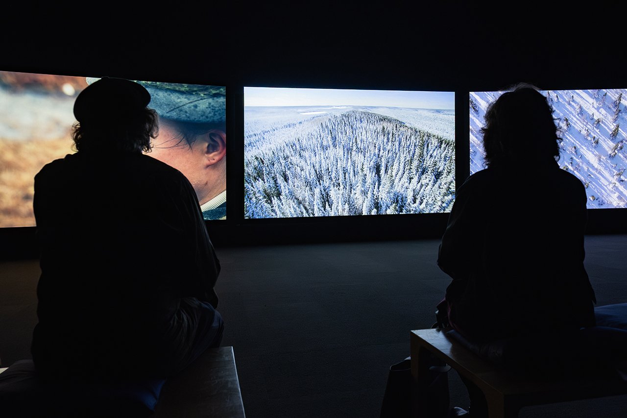 Visitors watch John Akomfrah’s multi-screen video installation Vertigo Sea, 2015
