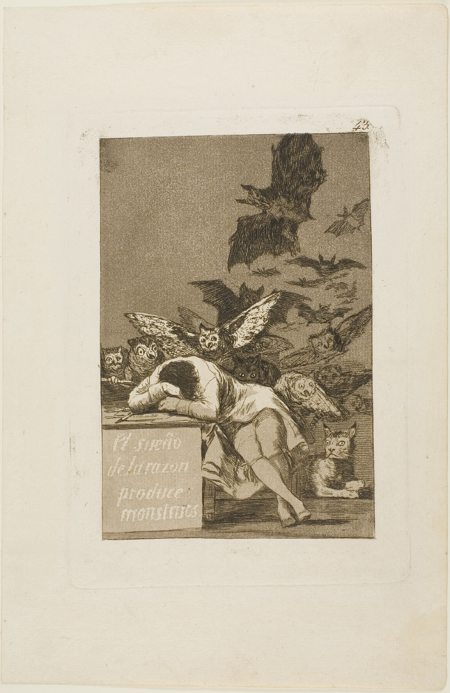 An etching of a man slumped asleep over a desk while owls and bats swarm out of the darkness behind him; the desk front is lettered with the Spanish title.