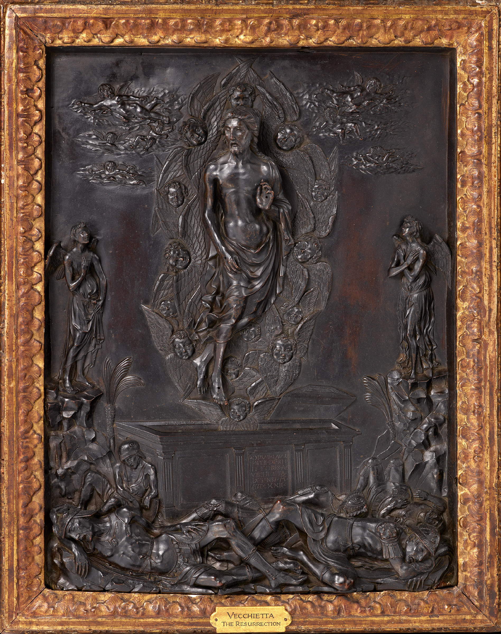 A gilded bronze relief of the risen Christ stepping from the tomb, arms raised, above sleeping soldiers in armour.