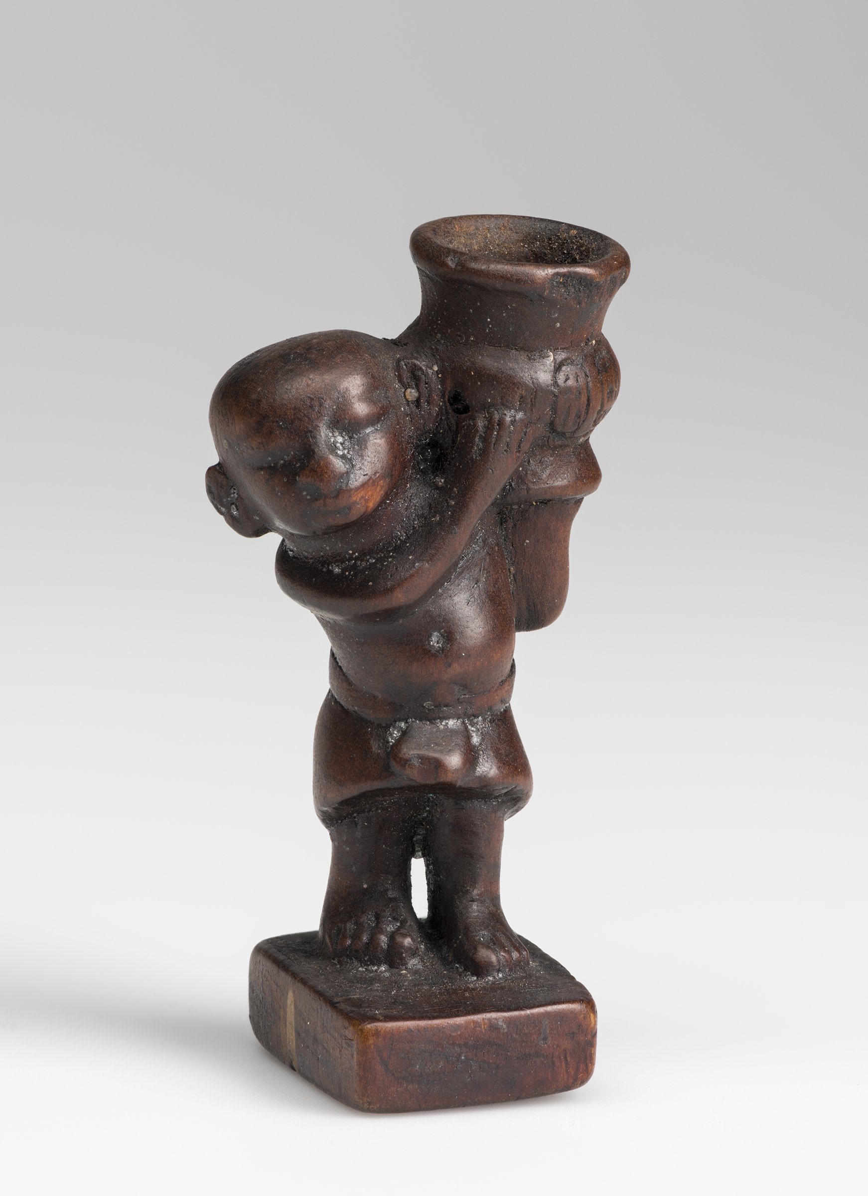 Boxwood figure of a dwarf holding a jar, 1349–1336 B.C.