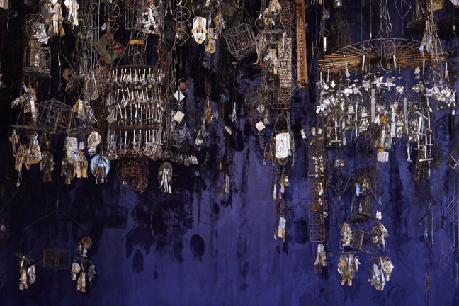Dense canopy of Emery Blagdon wire and foil Healing Machine components hanging in blue light