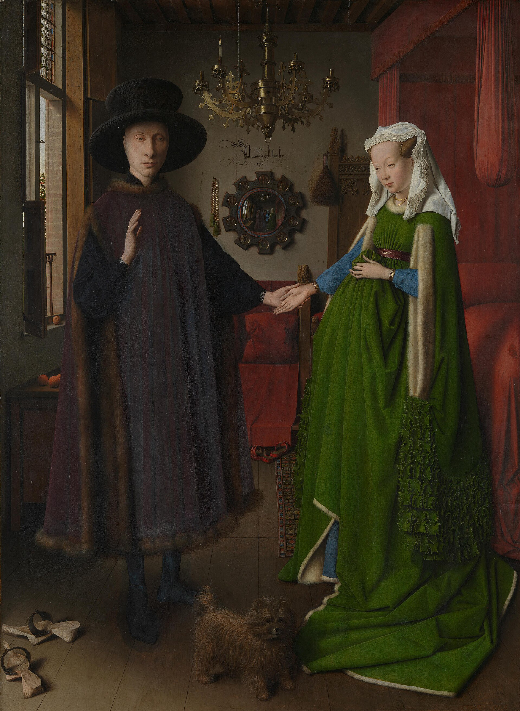 A man in a wide black hat and a woman in a voluminous green gown stand hand in hand in a Flemish bedchamber; a small dog sits at their feet and a convex mirror on the back wall reflects the room.