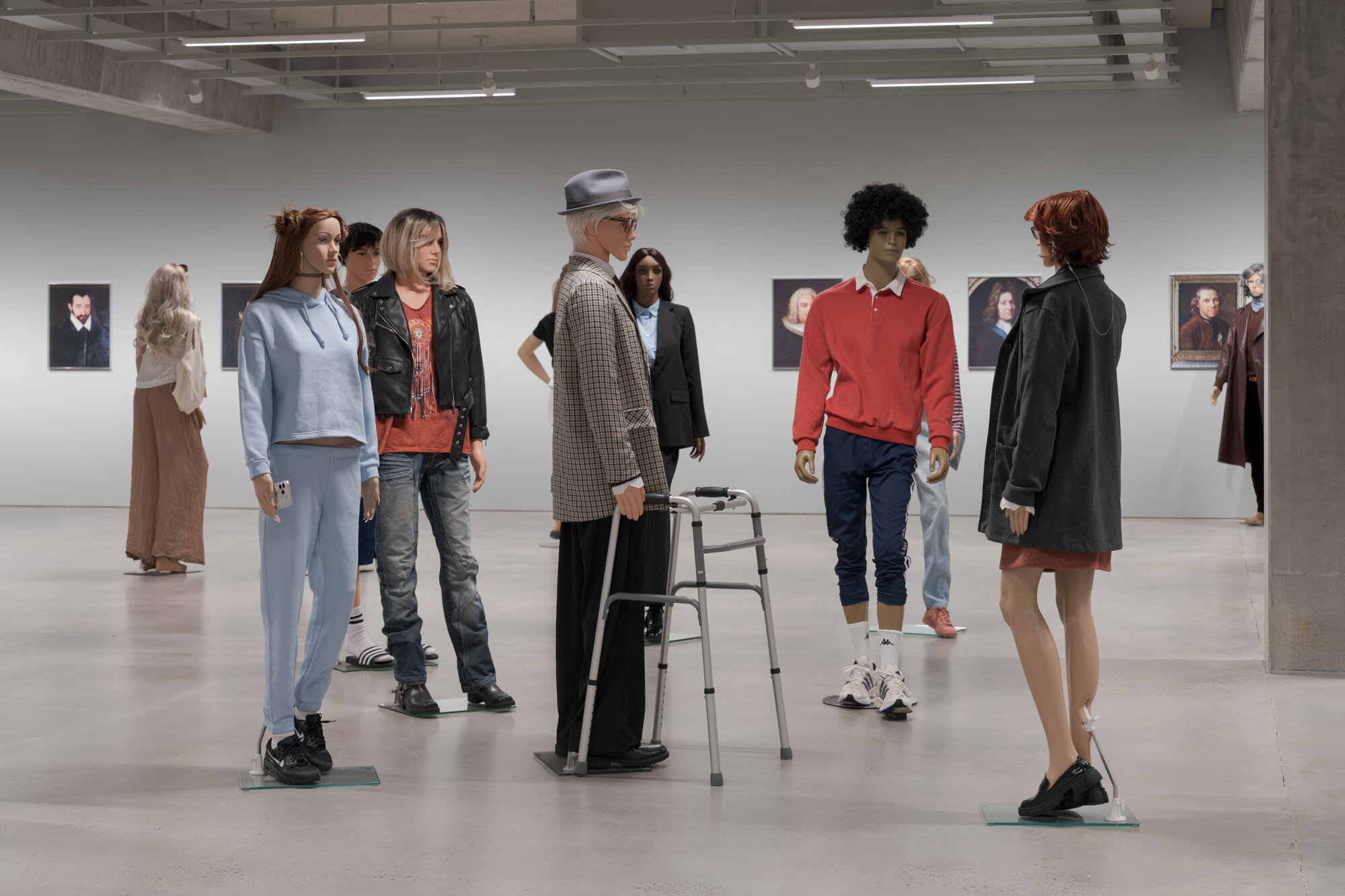 Installation view of "The Populace" at ARoS, a group of mannequins dressed in street clothing