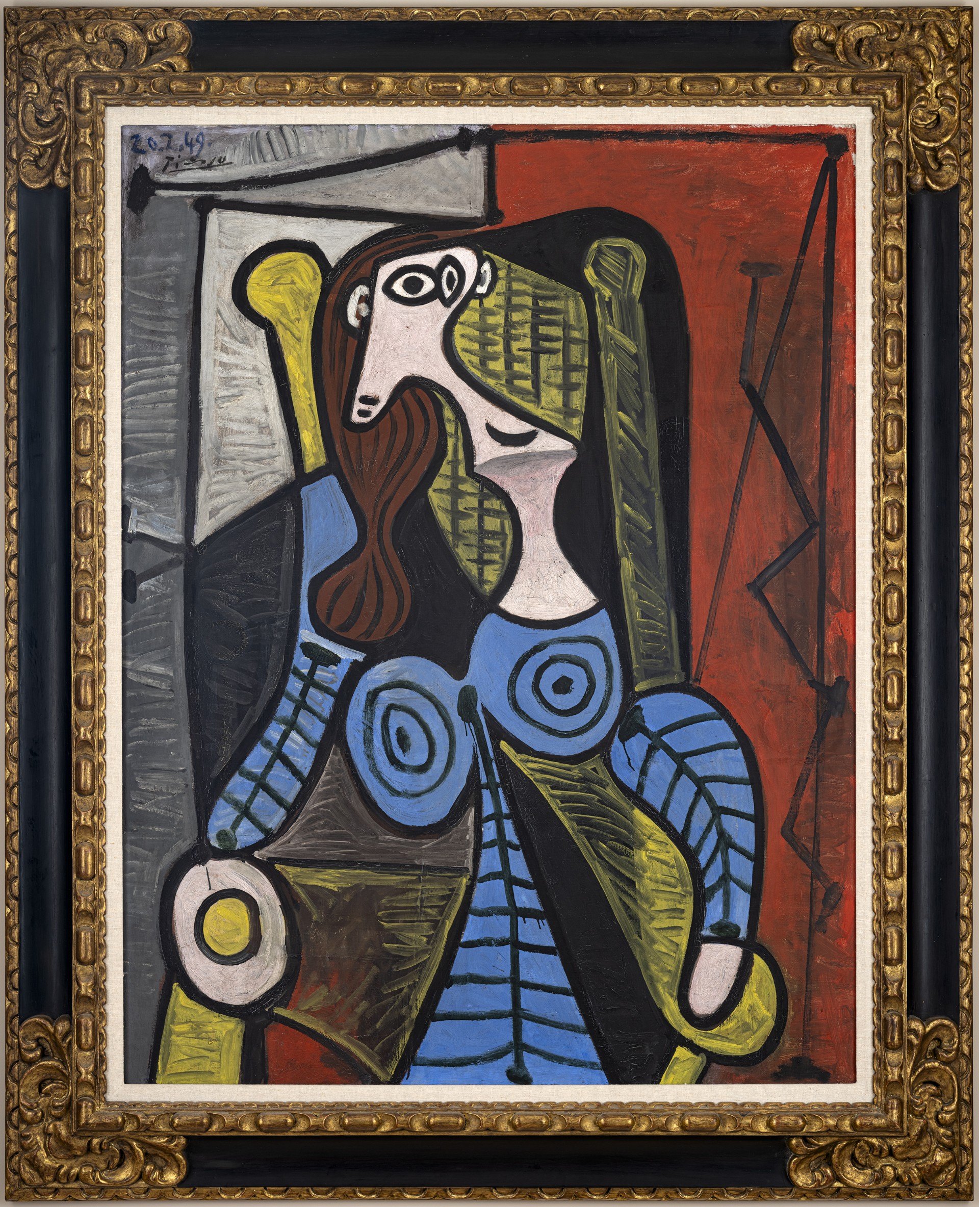 Pablo Picasso, Femme Assise: a seated woman painted in angular planes of blue, green and black