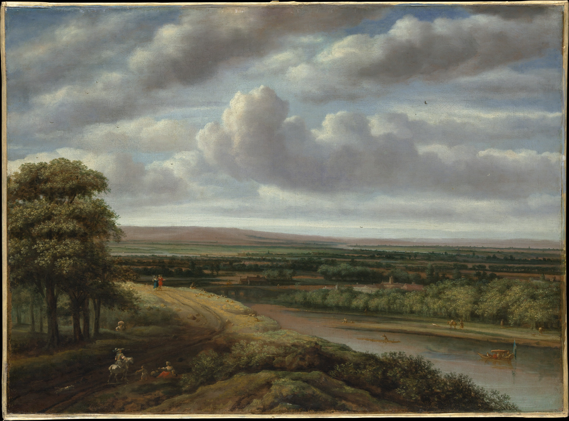 A panoramic Dutch landscape: a sandy track and clumps of trees in the foreground open onto flat fields and waterways stretching to the horizon, with a vast sky of piled cloud above.