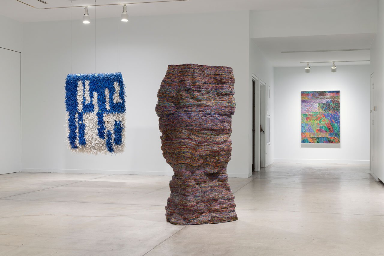Installation view of Vancouver Now! Emily Hermant, with a blue and white cable hanging and a tall cable column