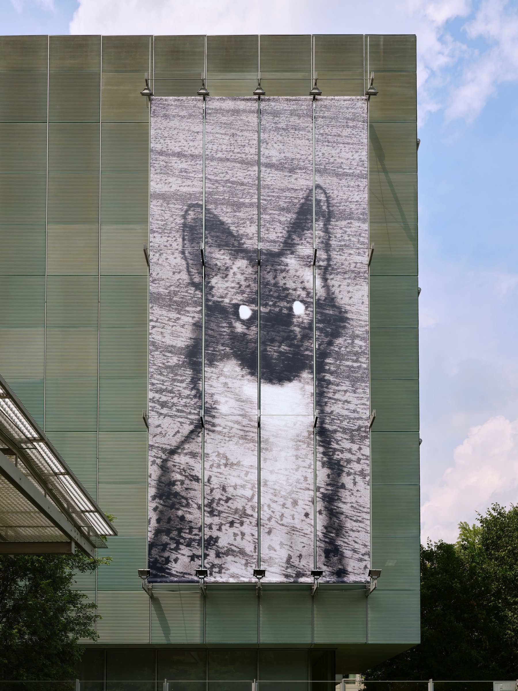 Close view of the façade image of a cat above the Gardner entrance