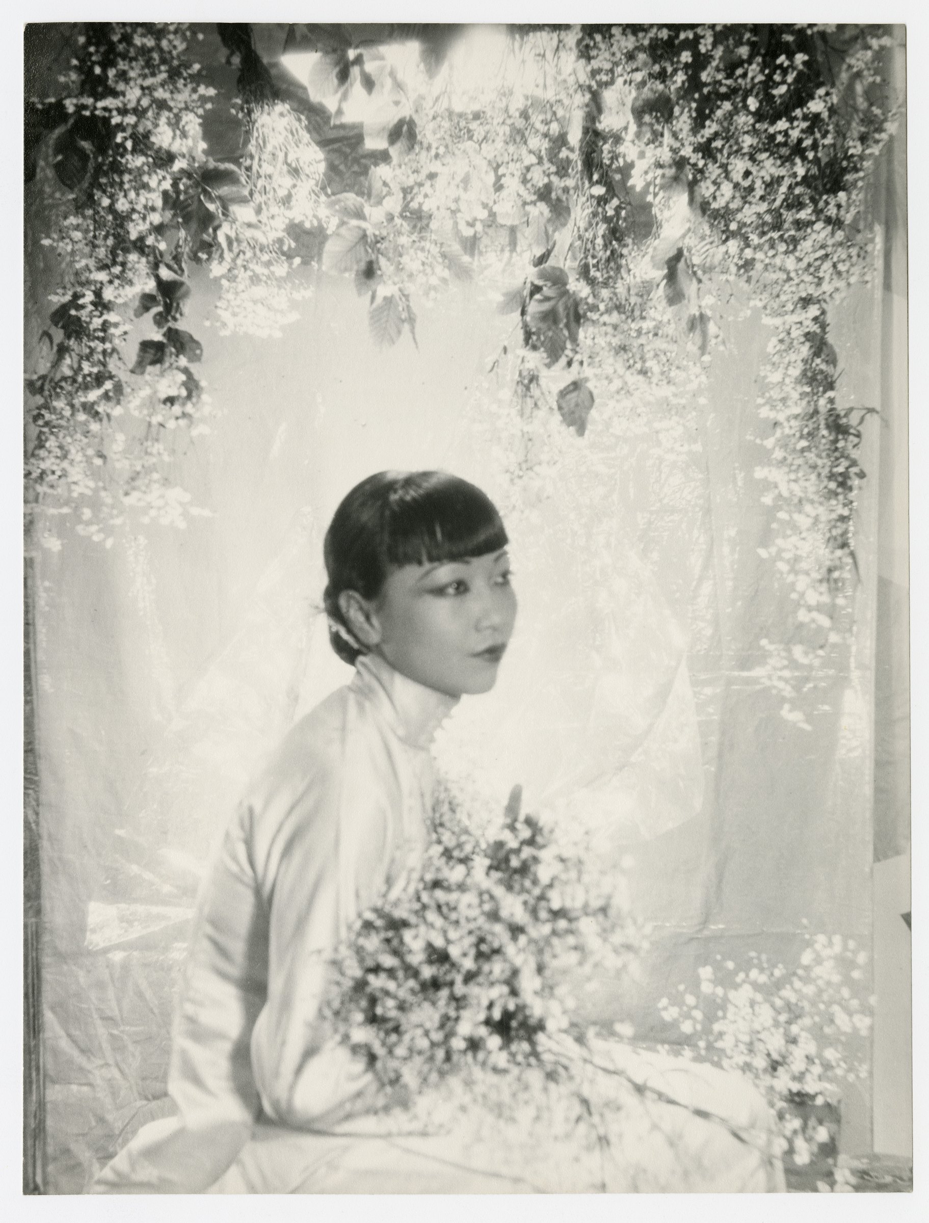 Cecil Beaton, Anna May Wong: the actor seated before a pale floral backdrop