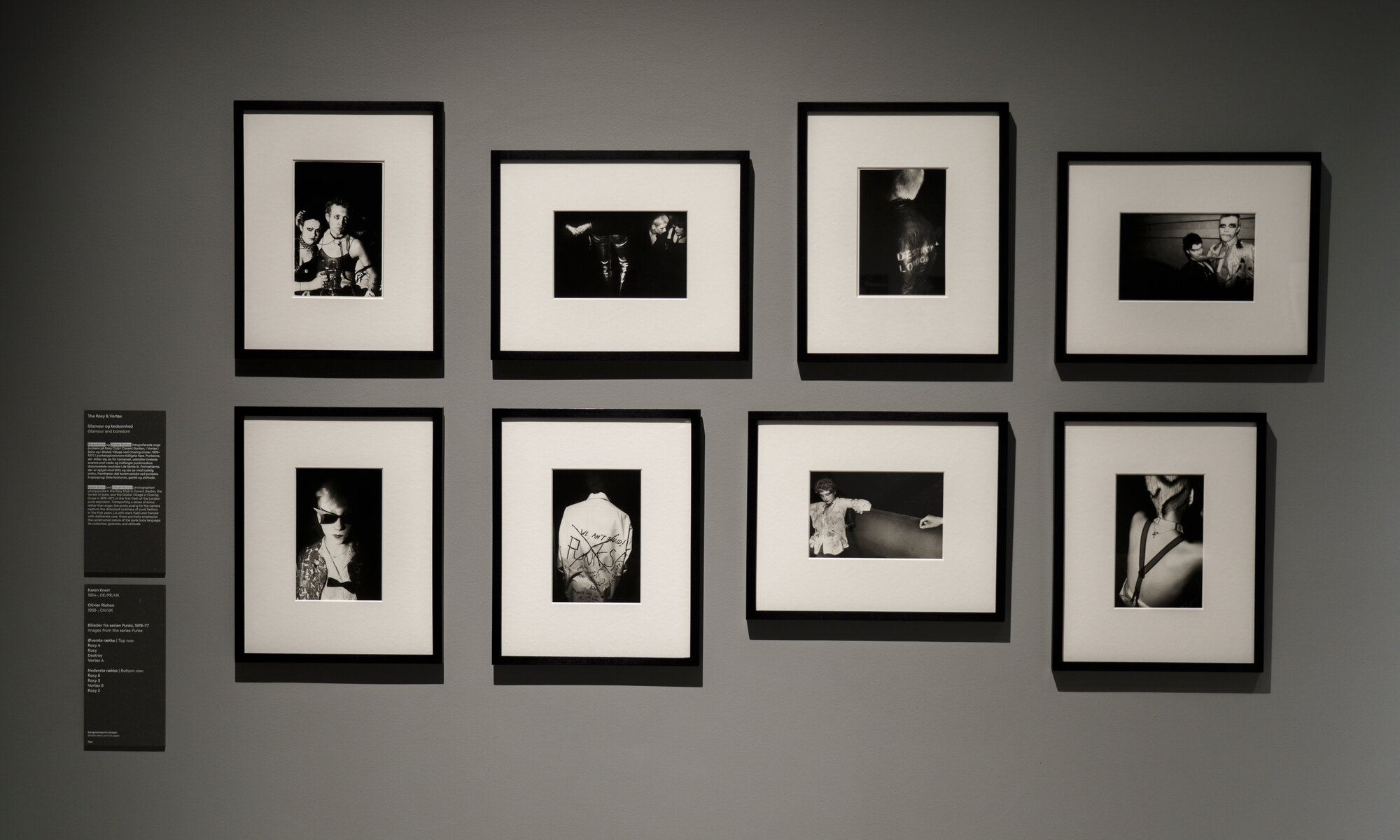 Installation view of "UNRULY: The Body in Punk" at ARoS, a grid of eight framed black-and-white photographs