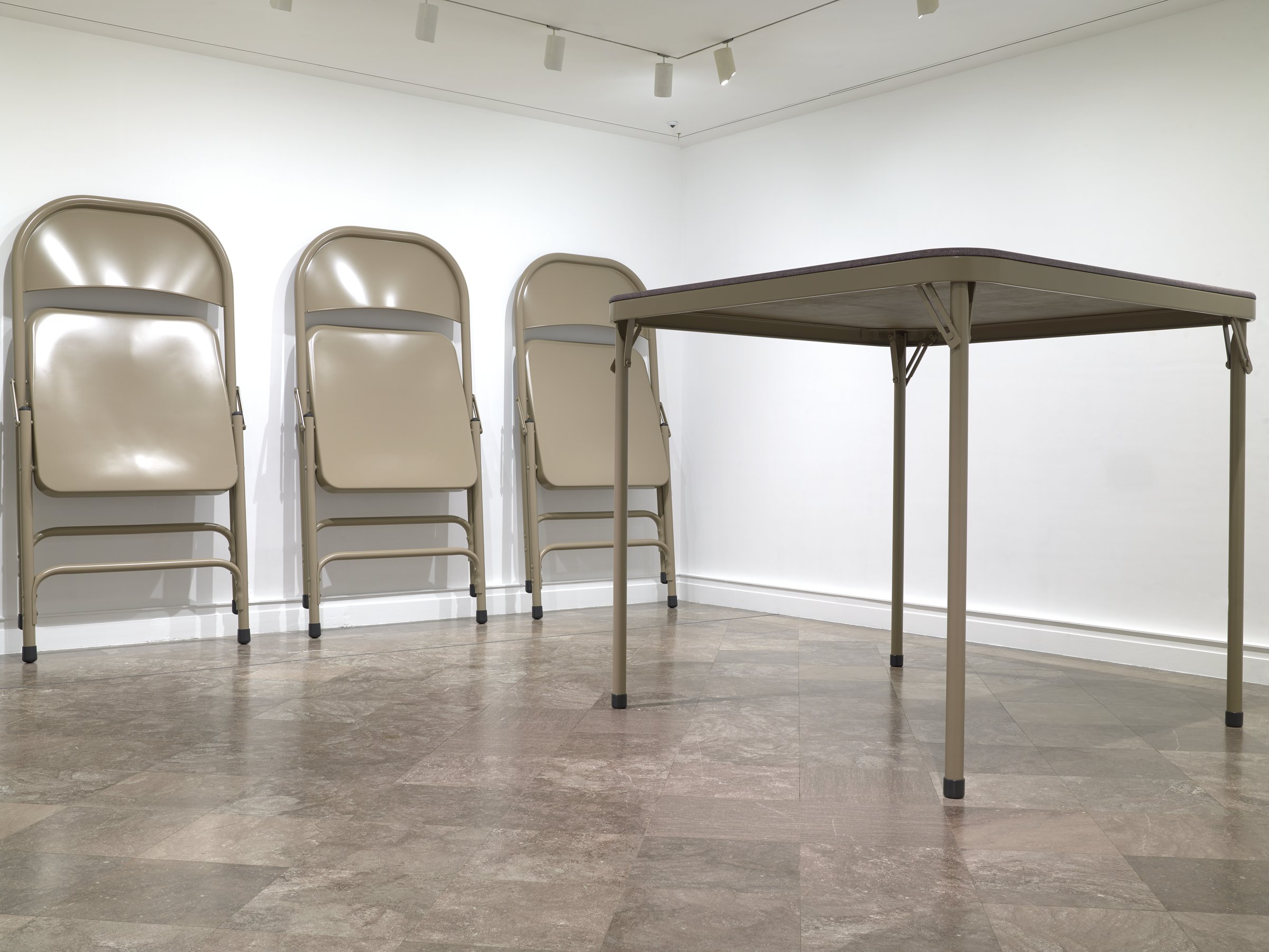Robert Therrien sculpture of an oversized beige folding table and folding chairs in a gallery