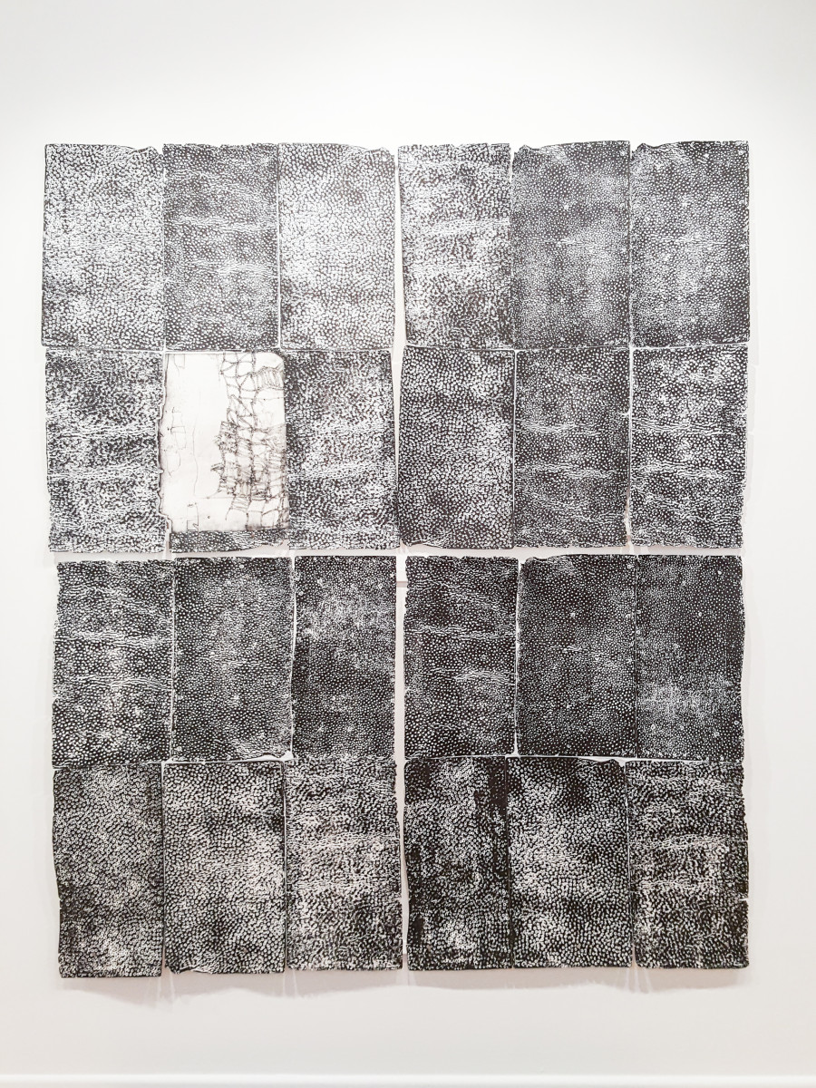El Anatsui, Untitled (Cassava Graters Imprints and Collage): a grid of black relief prints on sheets joined with copper wire