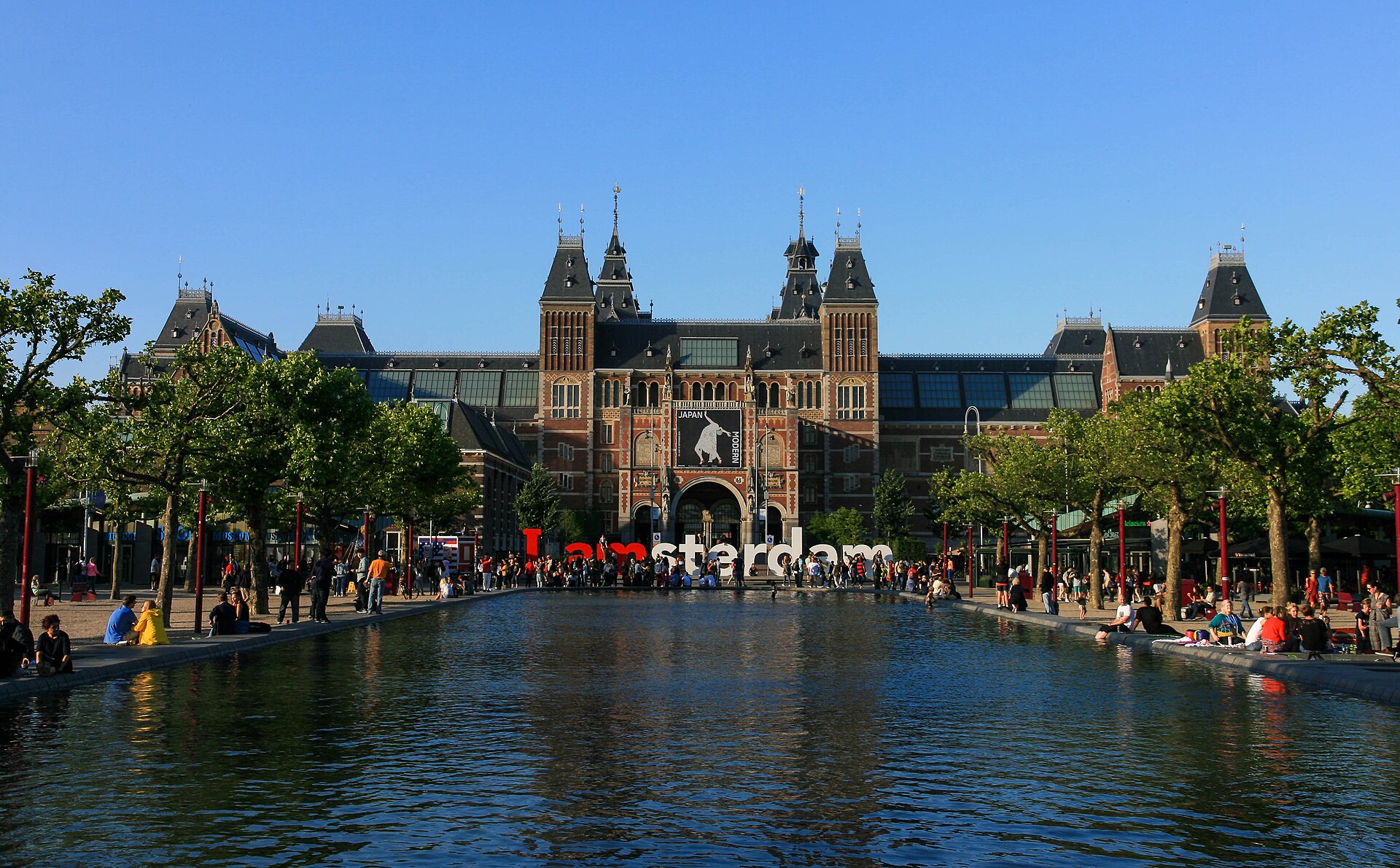 The Rijksmuseum in Amsterdam reflected in the long pool of the Museumplein.