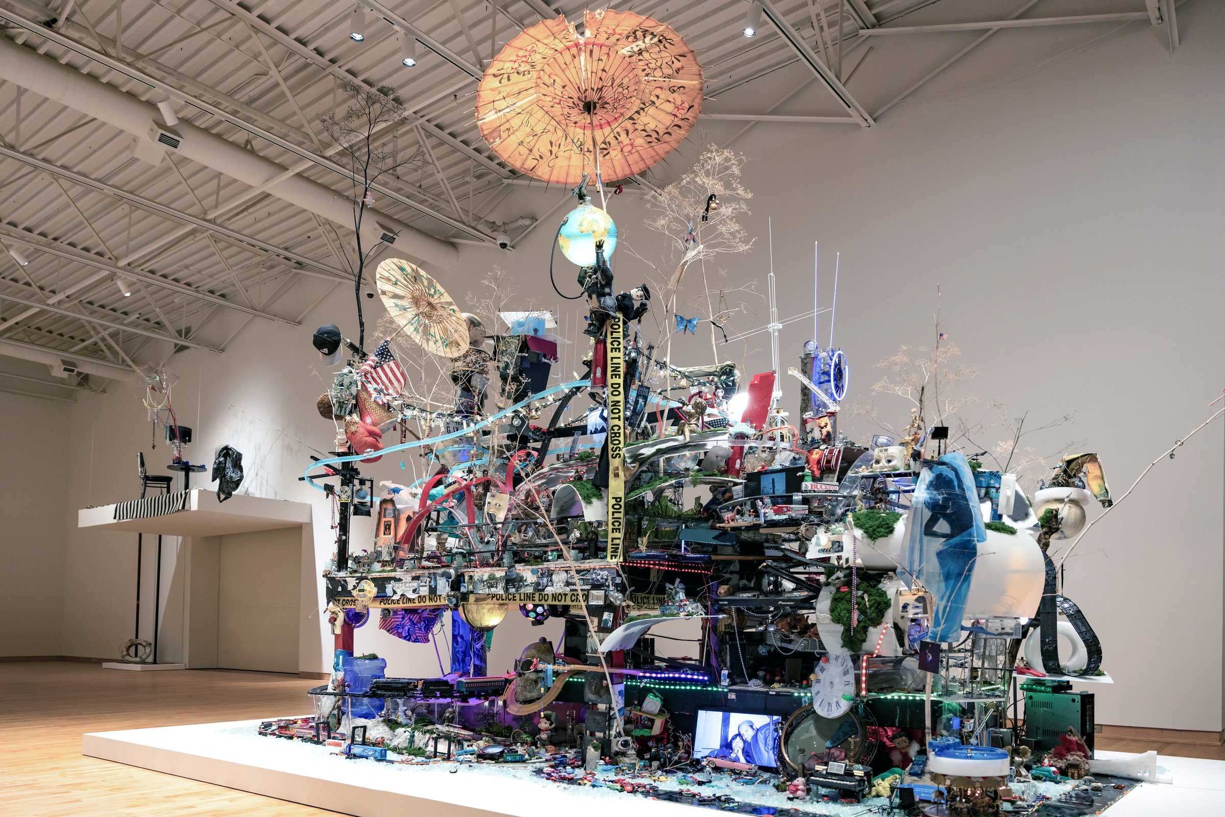 Robert Blackstone’s Crystal City seen from the side in the gallery, with a parasol and towers rising from the model city