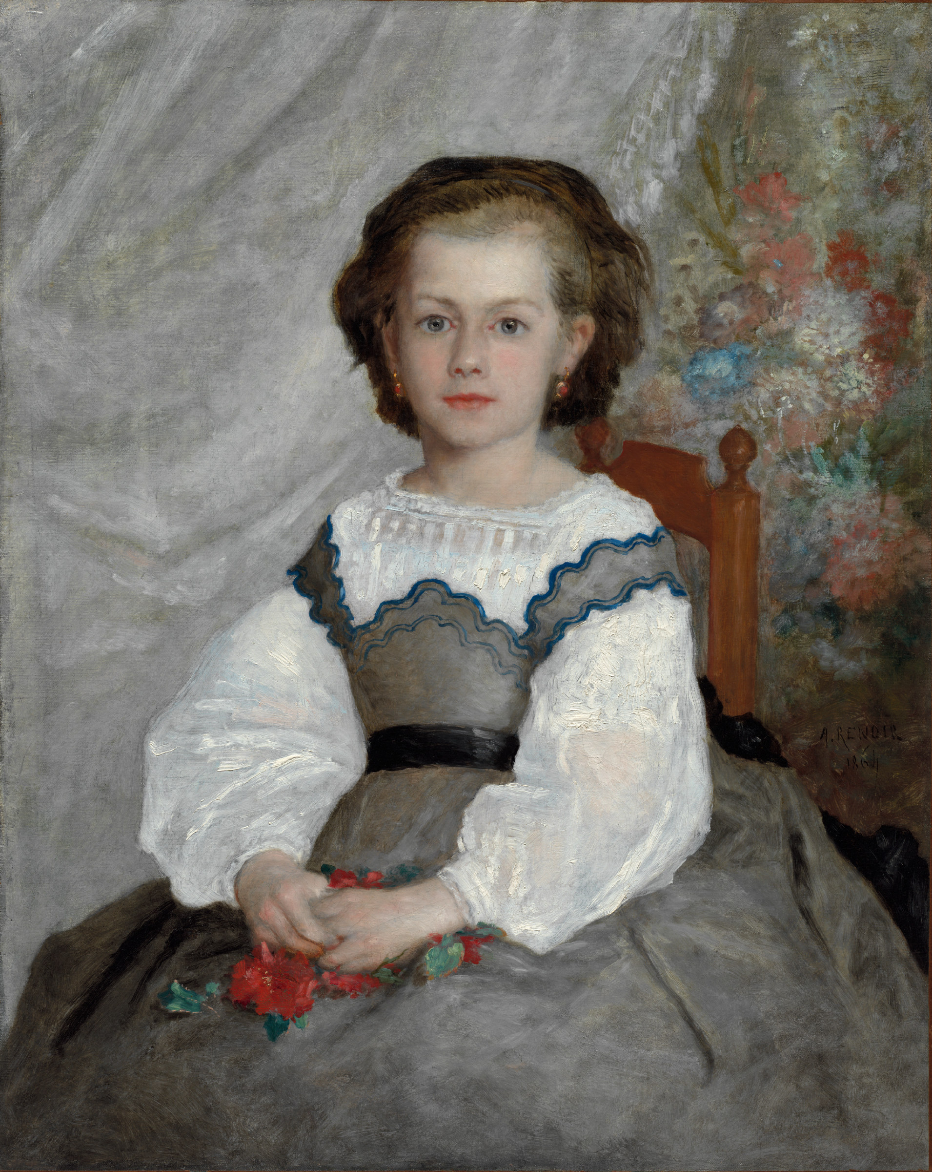 Portrait of a small girl seated upright in a chair, in a white dress with a dark sash, holding a loose posy of flowers in her lap against a soft grey-green background.
