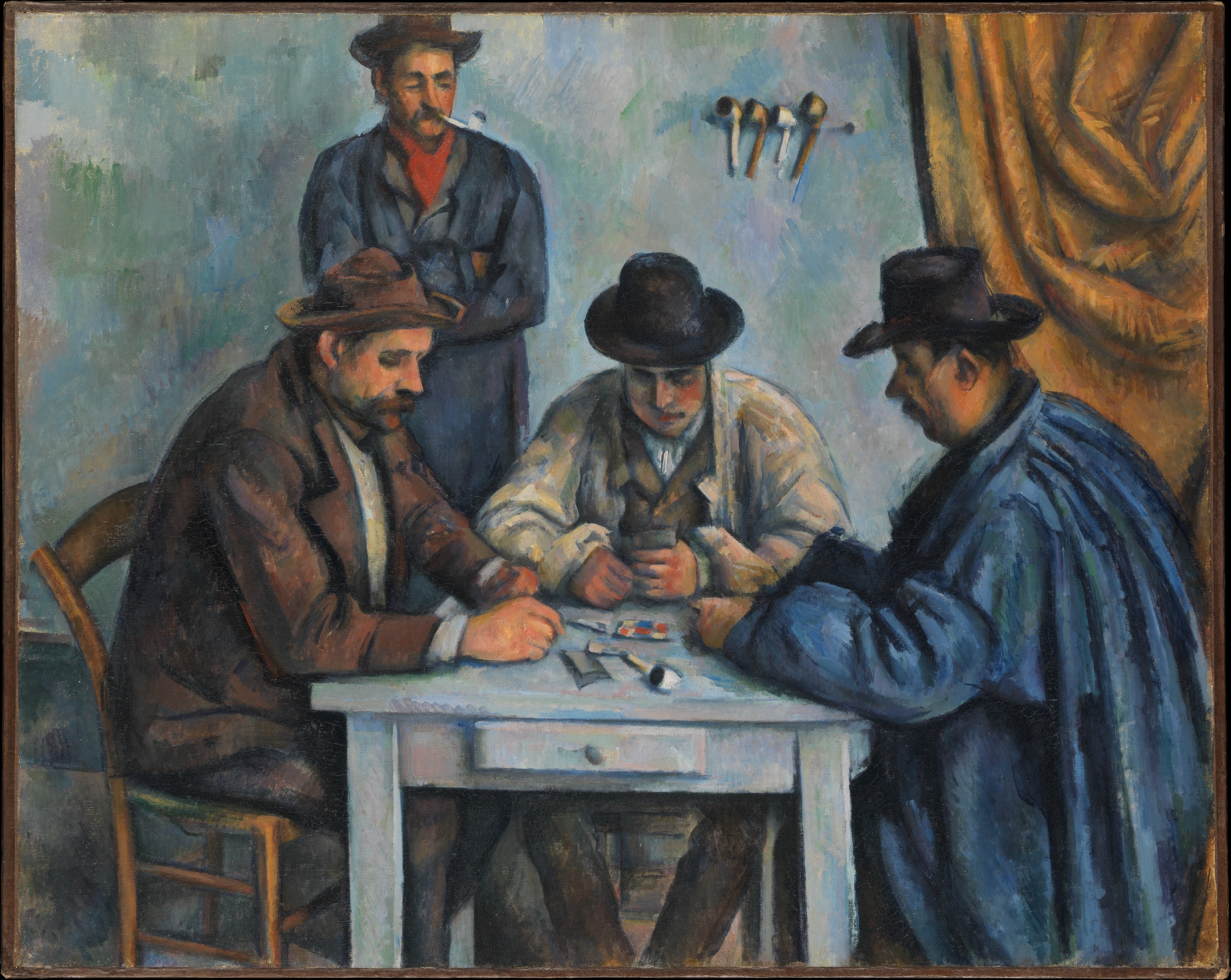 Four Provençal men gathered around a small pale table, three seated over their cards and one standing behind with a pipe, in front of a hanging ochre curtain.