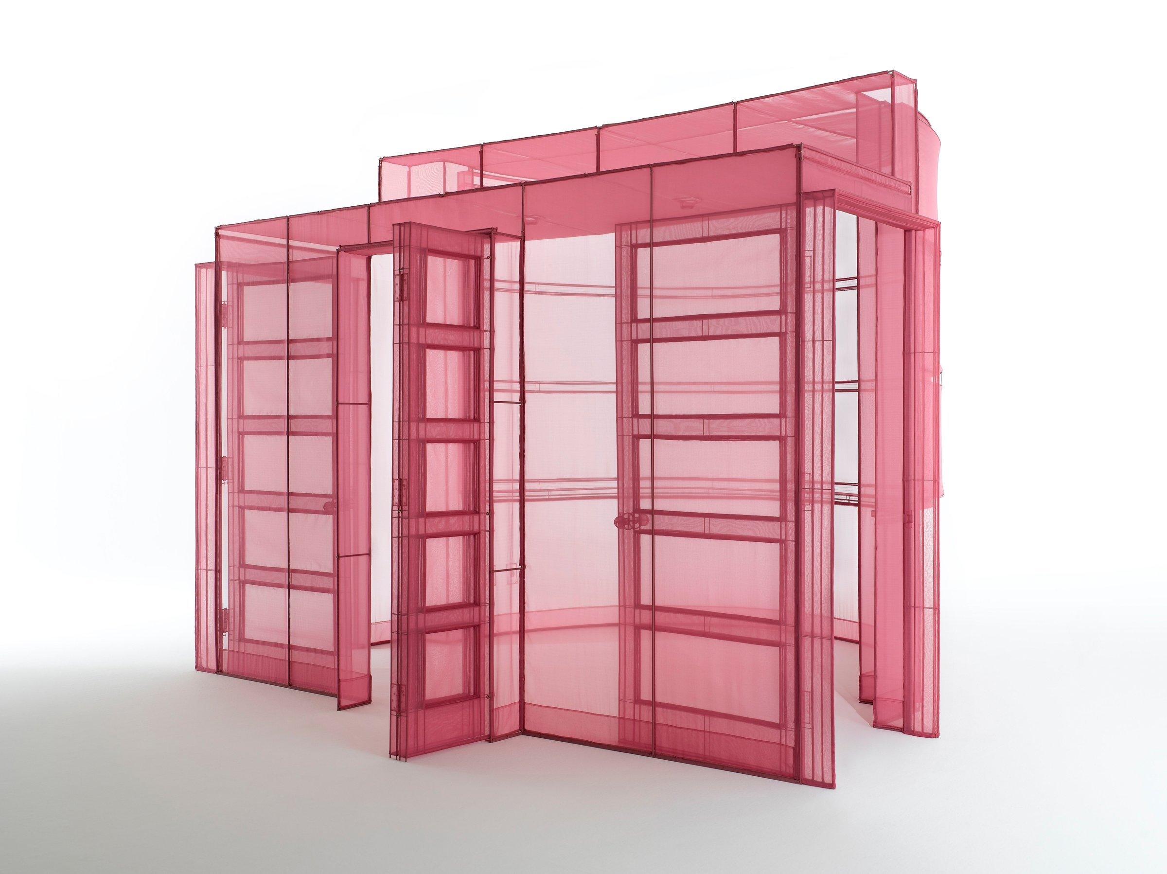 Do Ho Suh sculpture of a full-size room corner and doorways made of translucent pink fabric on steel frames