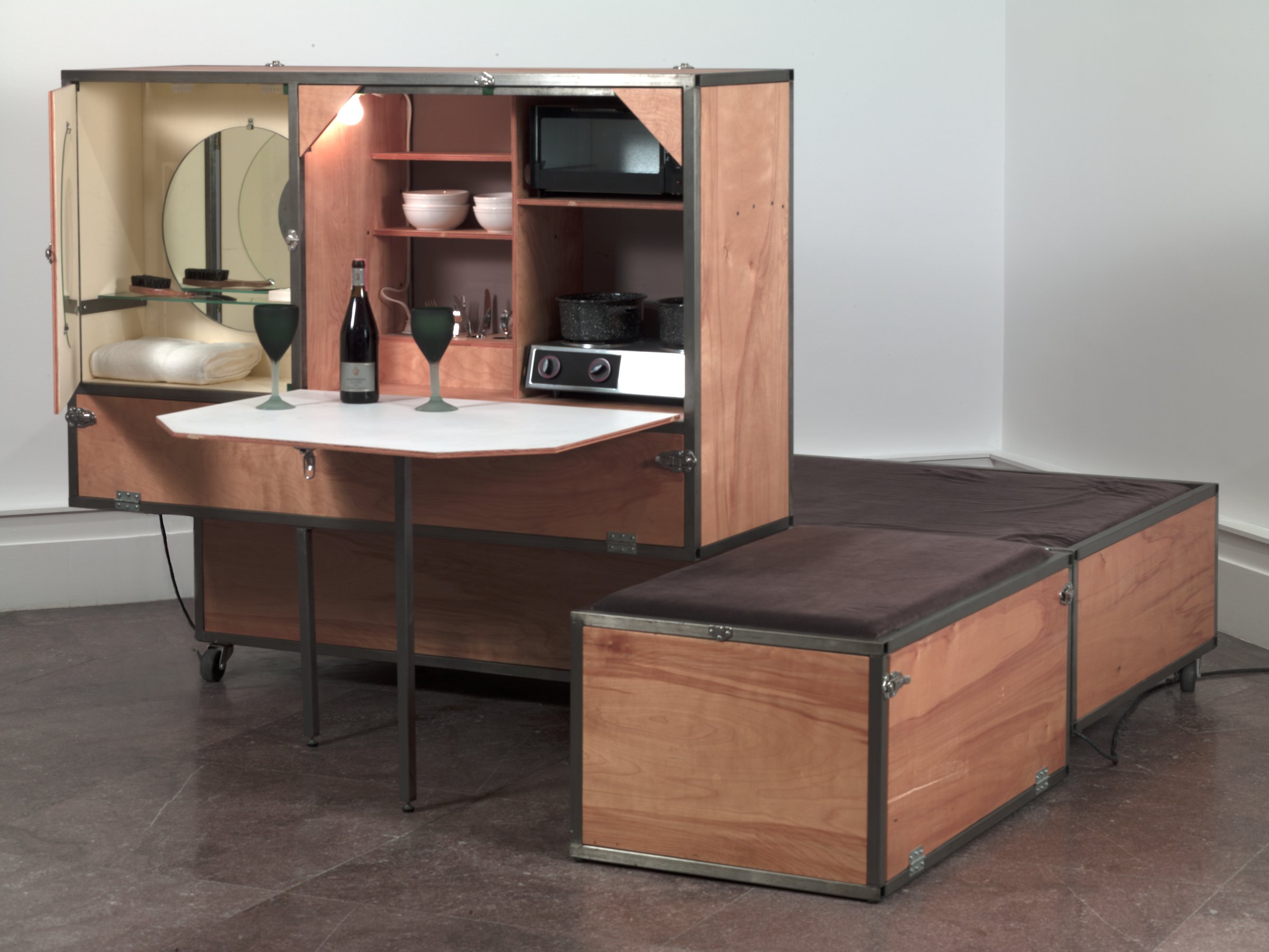 Andrea Zittel A to Z Living Unit: a fold-out wooden cabinet with a kitchen, shelves and a bed platform